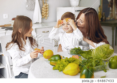 Family prepare the salad in a kitchen 64867433