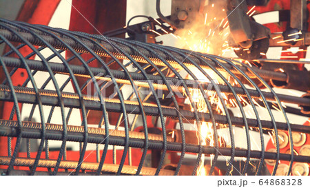Automatic welding with sparks in workshop 64868328