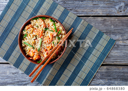 Fried rice with shrimps on clay bowl with sticks Fried rice with shrimps on clay bowl with sticks 64868380