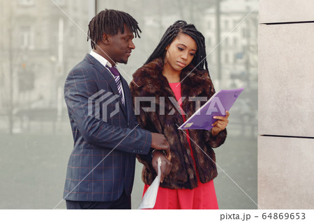 Stylish black couple have business conversation Stylish black couple have business conversation 64869653