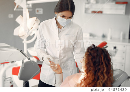 Beautiful girl sitting in the dentist's office 64871429