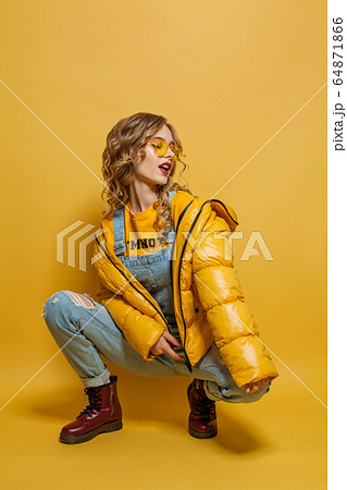 Fashionable model girl in yellow winter jacket Fashionable model girl in yellow winter jacket 64871866