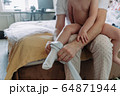 dad dresses his little daughter at home 64871944