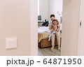 dad dresses his little daughter at home 64871950