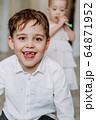 funny boy shows his tongue at home 64871952