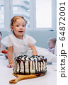 Portrait of cute little girl celebrating third birthday. 64872001