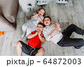 Cute little children having fun, lying on the floor in kindergarten 64872003