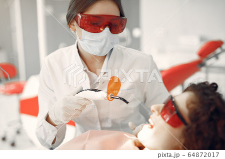 Beautiful girl sitting in the dentist's office 64872017