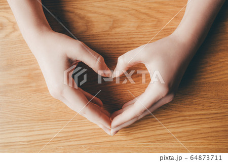 Female hands in the form of heart. Female hands in the form of heart. 64873711