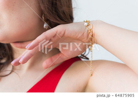 Close-up of woman wearing a Jewelry, bijouterie and accessories. Close-up of woman wearing a Jewelry, bijouterie and accessories. 64875905