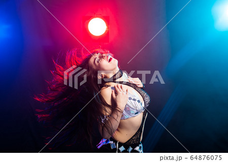 Girl dancing belly dance, fusion or tribal. A woman in a beautiful costume demonstrates charming and gentle movements in the dance. 64876075