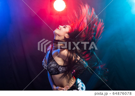 Belly dancer. Young attractive woman dancing tribal fusion on the stage. Oriental exotic dance. 64876078