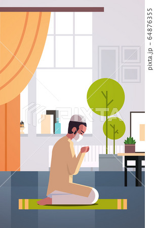 muslim man in mask praying ramadan kareem holy month religion coronavirus pandemic quarantine 64876355