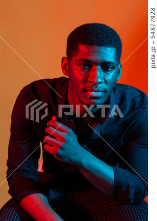 Dark neon portrait of young man wearing in shirt. Red and blue light. Technology Dark neon portrait of young man wearing in shirt. Red and blue light. Technology 64877928