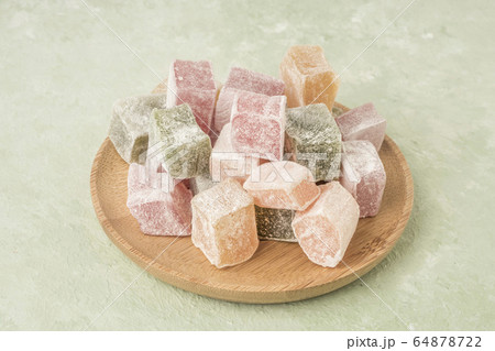 colorful Turkish delights on a green background 64878722