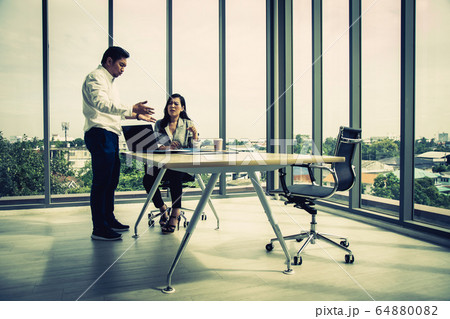 Manager Claiming to Businesswoman at Office 64880082