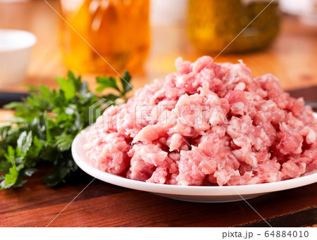 Raw minced meat close-up with parsley leaves on Raw minced meat close-up with parsley leaves on 64884010