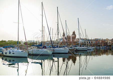 Beautiful sunset with boats moored in the harbor, 64884986