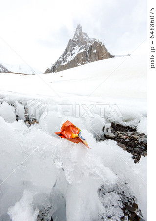 Garbage scattered over snowy mountain. Let's save the planet and recycle the excess garbage. Pollution Concept 64886075