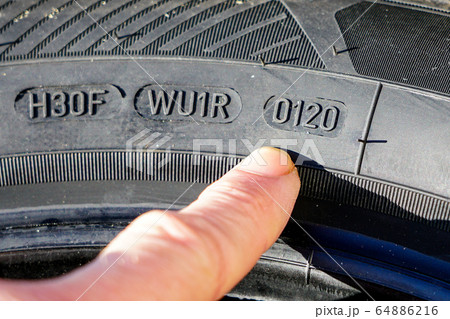Side view of tire with designation of week and Side view of tire with designation of week and 64886216