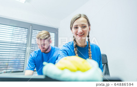Man and woman team of commercial cleaners working Man and woman team of commercial cleaners working 64886594