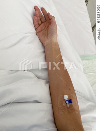 Female patient receiving intravenous treatment in clinic 64888036
