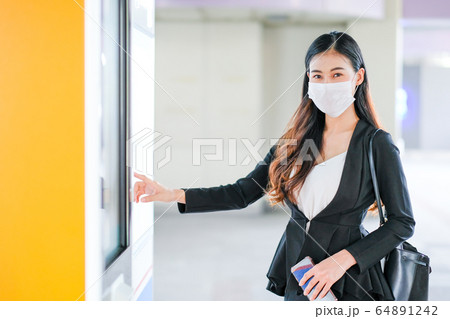 Beautiful business woman with hygiene mask point to sky train or transportation map Beautiful business woman with hygiene mask point to sky train or transportation map 64891242