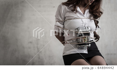 The woman was kidnapped as a hostage and tied to a 64894442