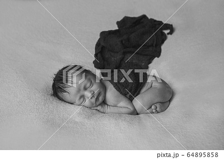 the concept of healthy lifestyle, IVF - a newborn baby sleeps under a blanket. Copy space 64895858
