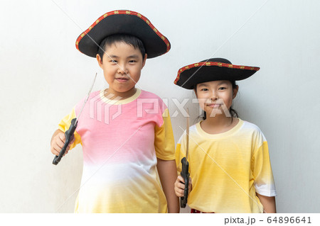Asian boy and girl smiling in pirate costume Asian boy and girl smiling in pirate costume 64896641