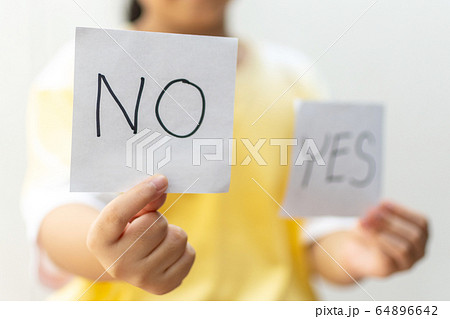 Girl holding paper with No Girl holding paper with No 64896642