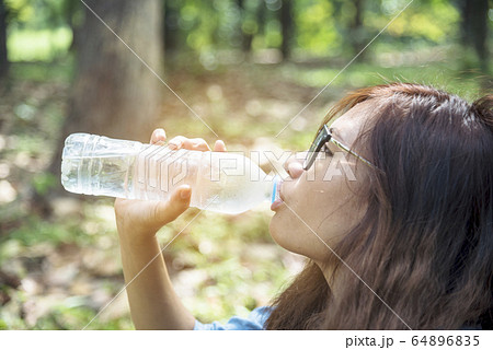 Healthy woman holding mineral drinking water in Healthy woman holding mineral drinking water in 64896835