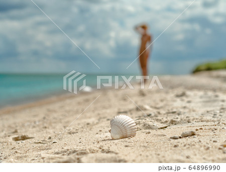 young nudism beach Young nude free calm female posing looking away while lying ...