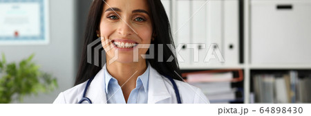 Beautiful smiling GP holding in hands red toy heart 64898430