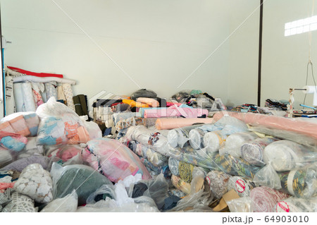 Stack of fabric raw material. Clothing in plastic 64903010