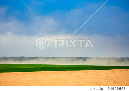 Dust storm in dry fields, dry weather infuenced by climate change 64906663