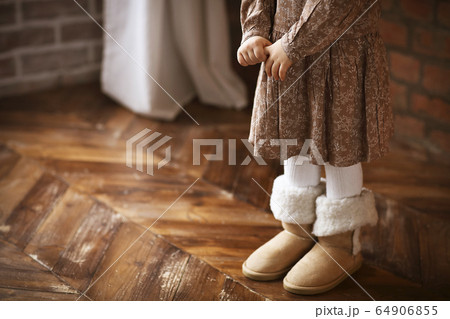Faceless littlegirl in warm clothes and footwear 64906855