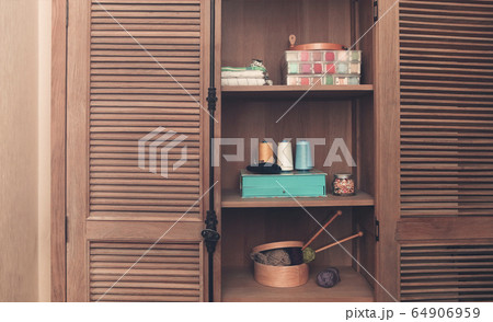 Sewing accessories in retro wooden cupboard Sewing accessories in retro wooden cupboard 64906959