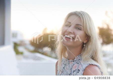 Beautiful young blond woman outdoors portrait near Beautiful young blond woman outdoors portrait near 64908838