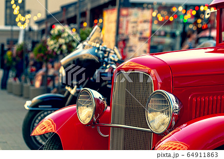 Vintage red car on the street in summer 64911863
