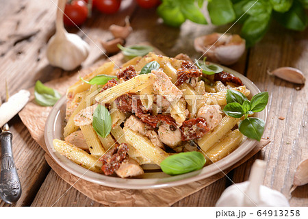 Penne pasta with chicken, dried tomatoes and Penne pasta with chicken, dried tomatoes and 64913258