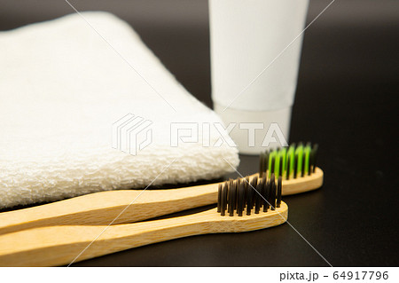 Set of environmentally friendly toothbrushes and toothpaste on a black background. Dentistry and healthcare concept. Set of environmentally friendly toothbrushes and toothpaste on a black background. Dentistry and healthcare concept. 64917796