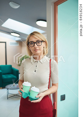 Young businesswoman with coffee Young businesswoman with coffee 64918234