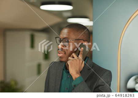 Businessman using mobile phone 64918263