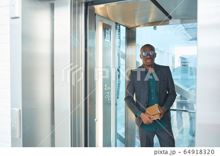 Businessman standing in the elevator Businessman standing in the elevator 64918320