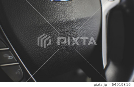 SRS Airbag icon on steering wheel. 64919316