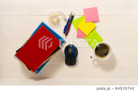 Home office concept. Work from home. Books and cafe cuo on the white wooden background. Top view. Sweden. Home office concept. Work from home. Books and cafe cuo on the white wooden background. Top view. Sweden. 64919742