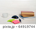 Home office concept. Work from home. Books and cafe cuo on the white wooden background. Side view 64919744