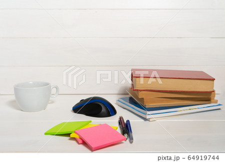 Home office concept. Work from home. Books and cafe cuo on the white wooden background. Side view 64919744