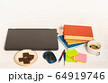 Home office concept. Work from home. Black laptop, books and cafe cuo on the white wooden background. Side view.  64919746